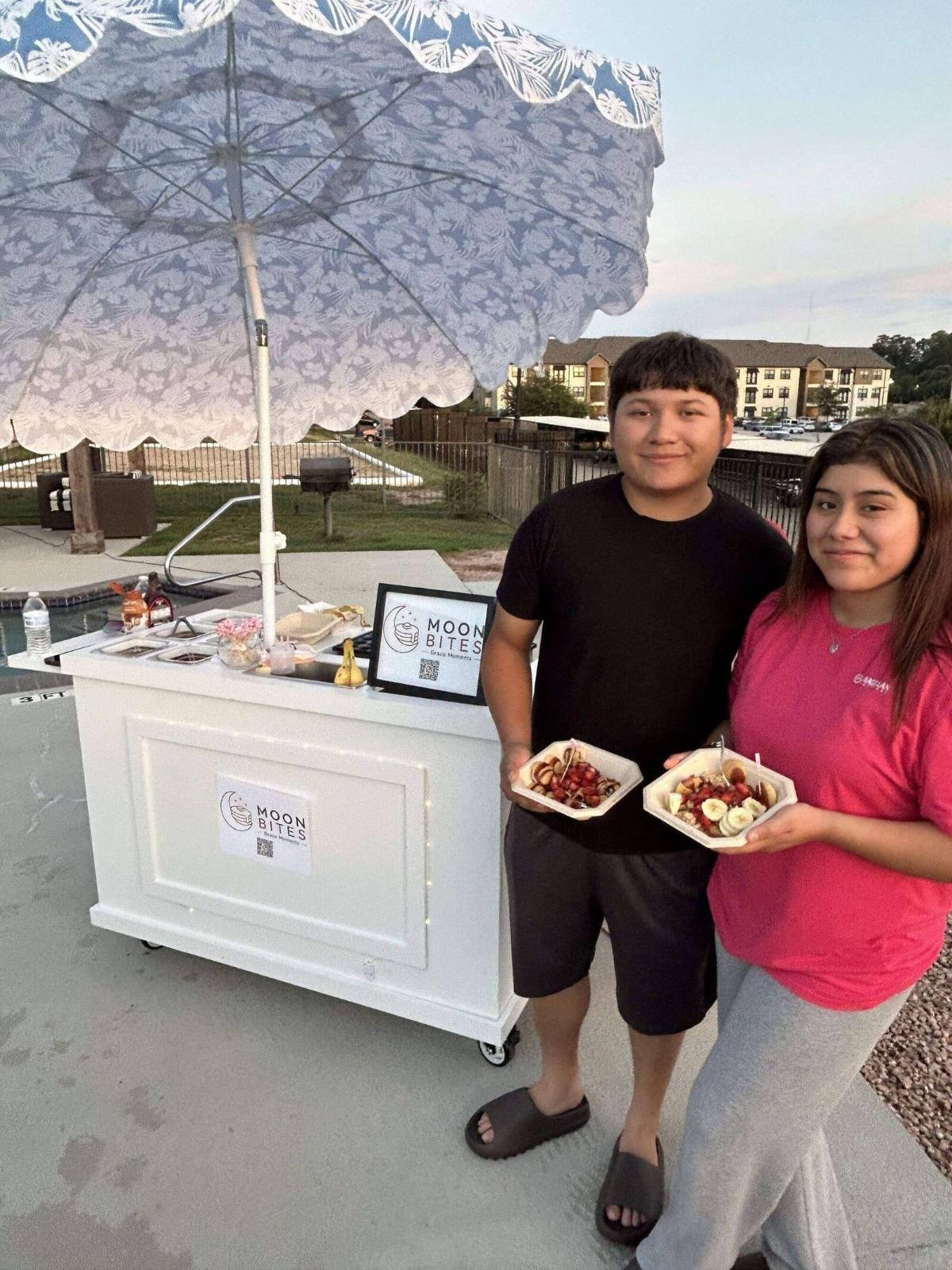 Guests holding boxes of mini pancakes